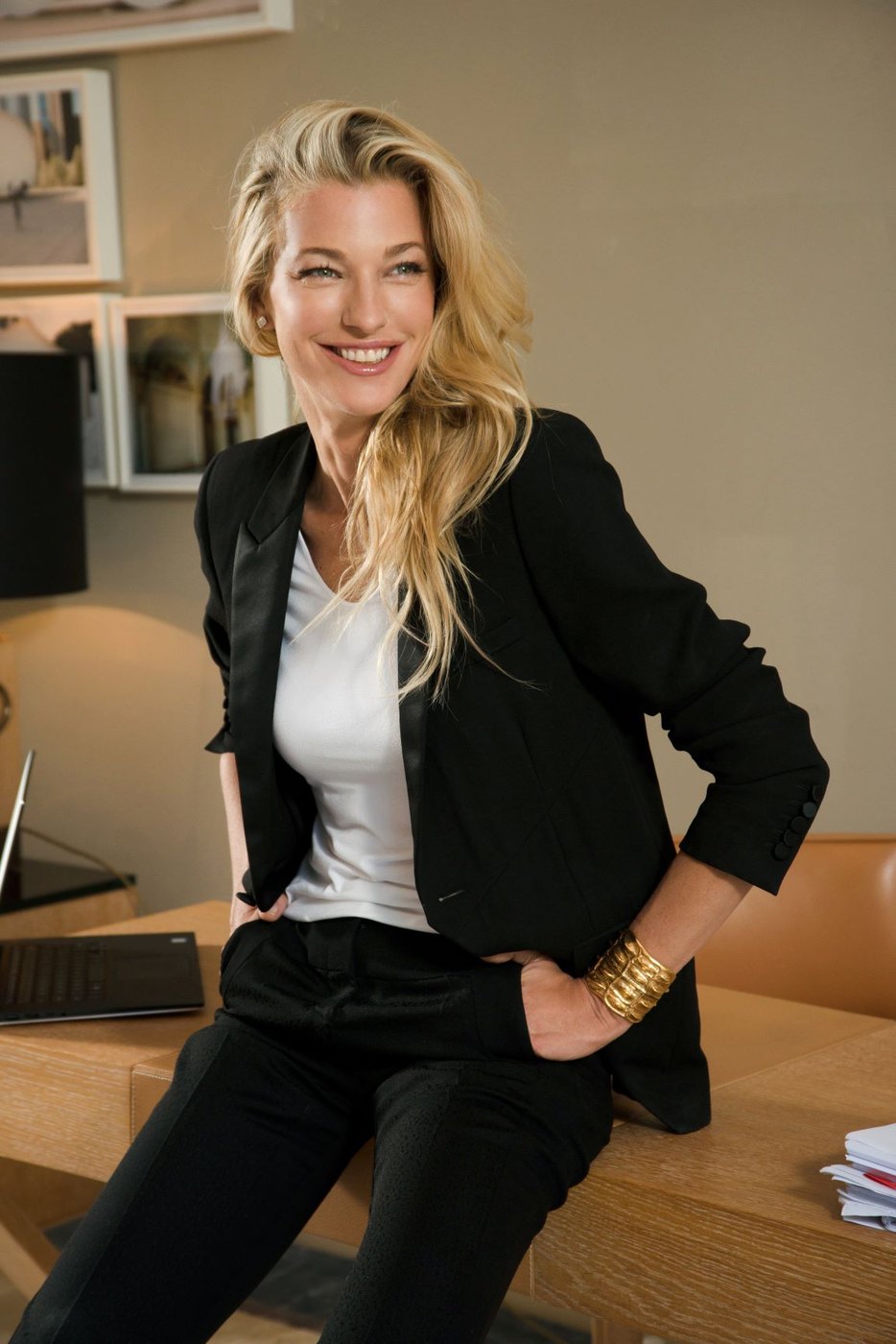 Nicole Junkermann smiling in a dark blazer in a bright office
